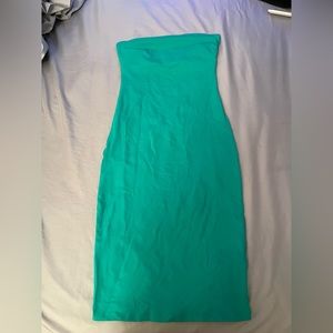 Long green strapless skin tight dress.
